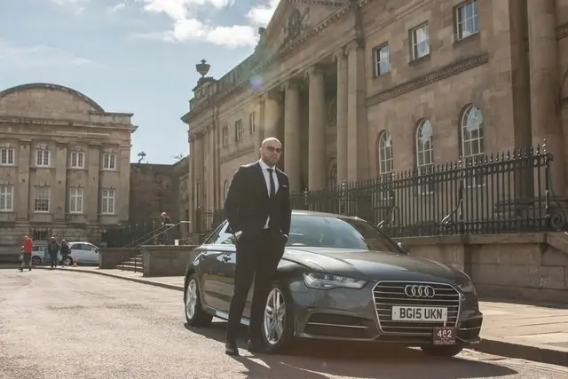 York Cars driver standing beside an executive car in York